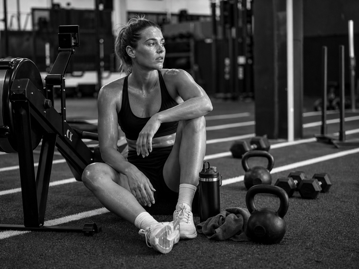 An athlete resting between sets in a gym